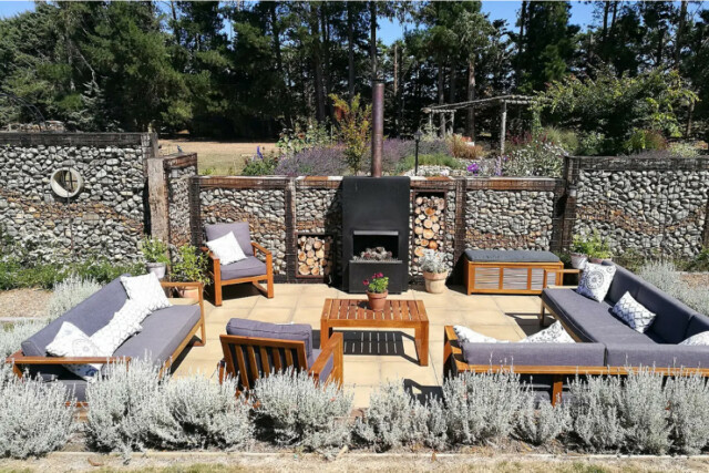 A patio with a fire pit and furniture.
